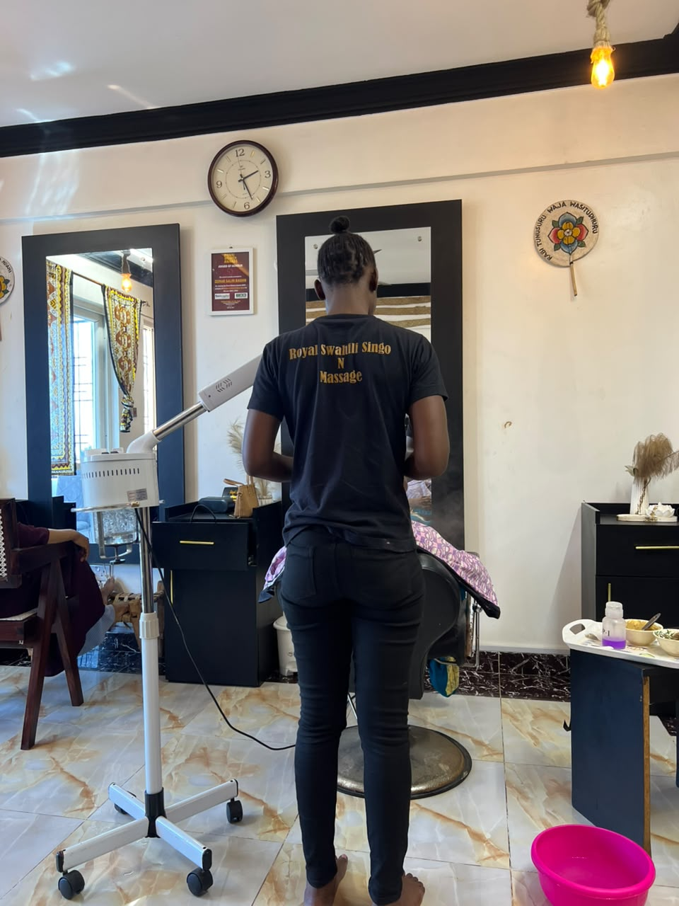 Royal Swahili staff performing a facial treatment on a guest