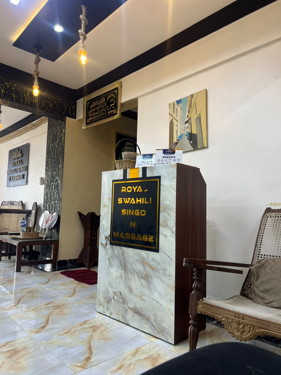Royal Swahili Singo N Massage marble reception desk with brand signage in Mombasa