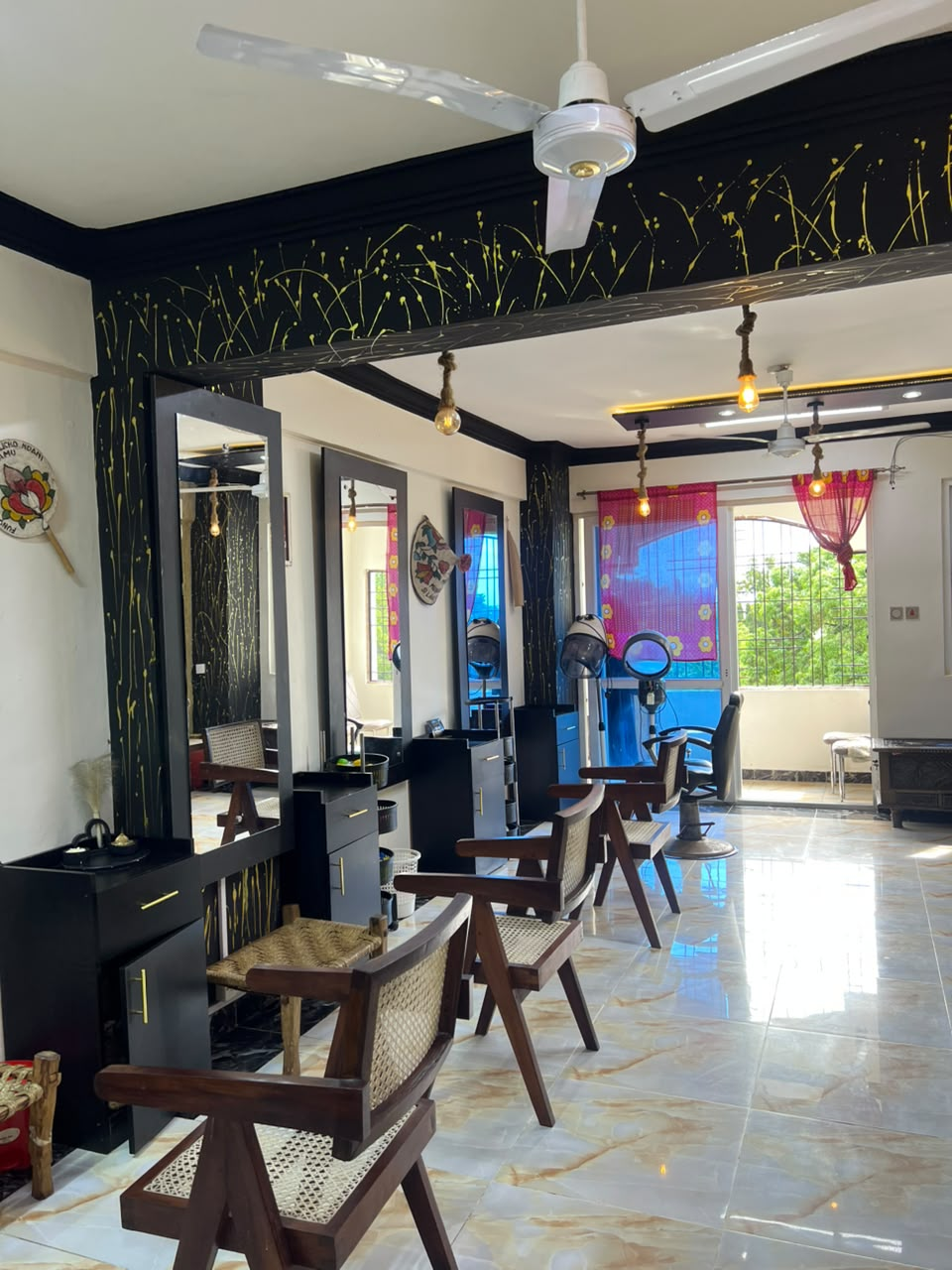 Ladies salon styling stations with gold accents at Tudor branch